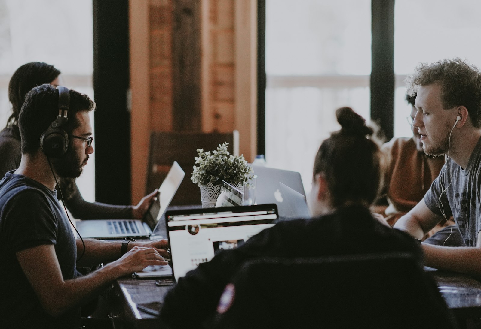 A startup team collaborating over laptops